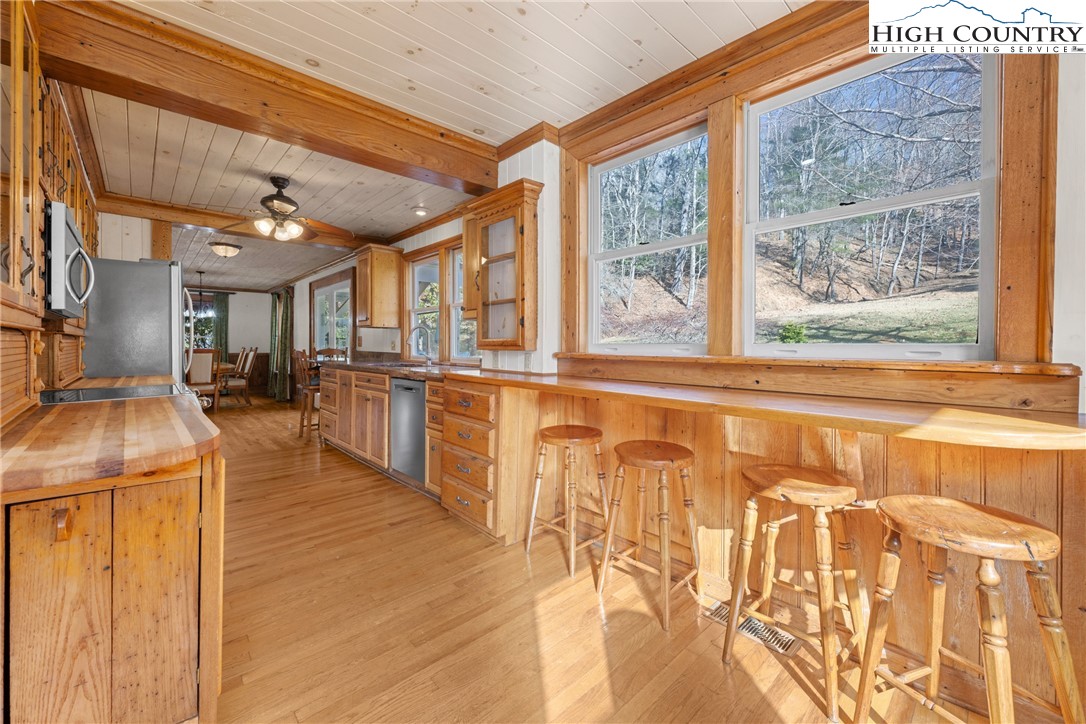 211 Possum Hollow Road Blowing Rock, NC 28605 - Photo 13 of 46 a view of a kitchen with furniture and large windows