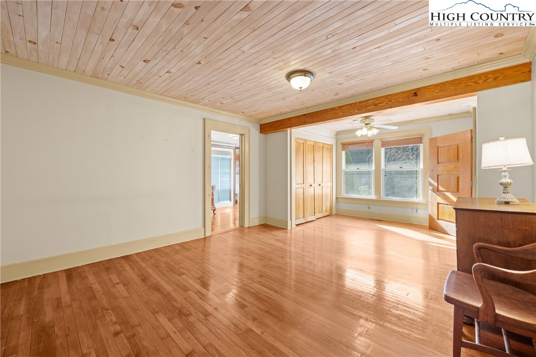 211 Possum Hollow Road Blowing Rock, NC 28605 - Photo 17 of 46 a view of an empty room with window and wooden floor