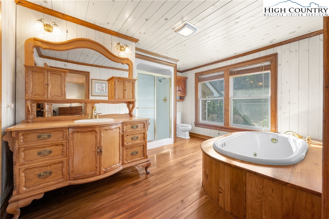 211 Possum Hollow Road Blowing Rock, NC 28605 - Photo 18 of 46 a spacious bathroom with a granite countertop tub sink and mirror