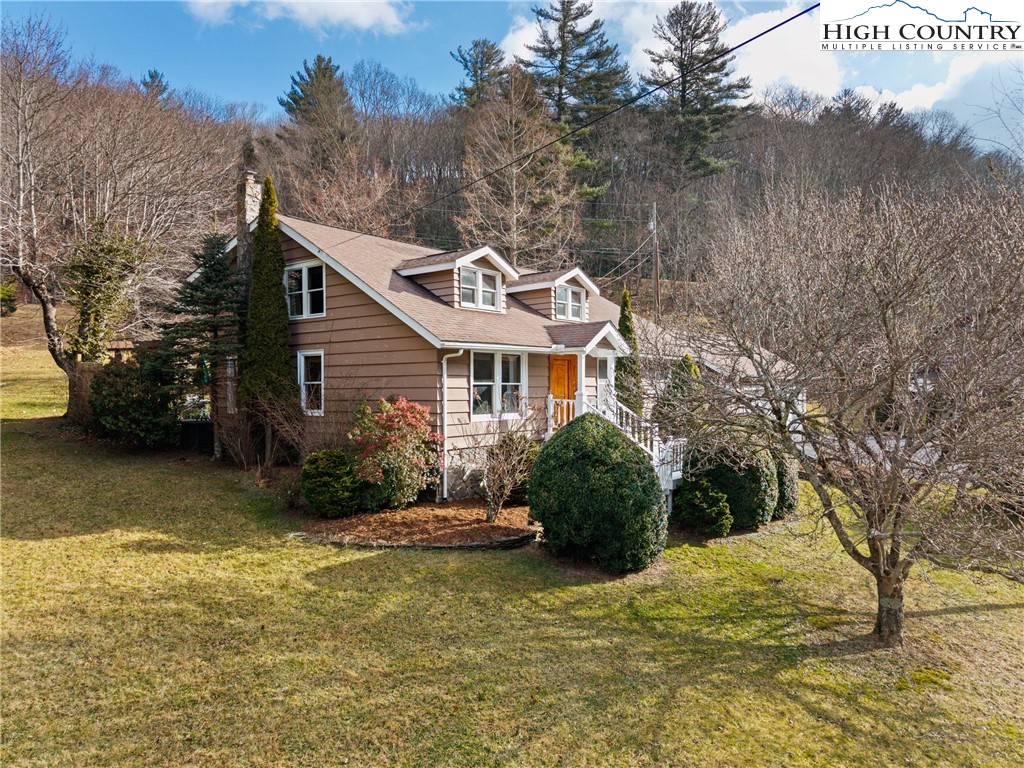 211 Possum Hollow Road Blowing Rock, NC 28605 - Photo 2 of 46 a front view of a house with a garden