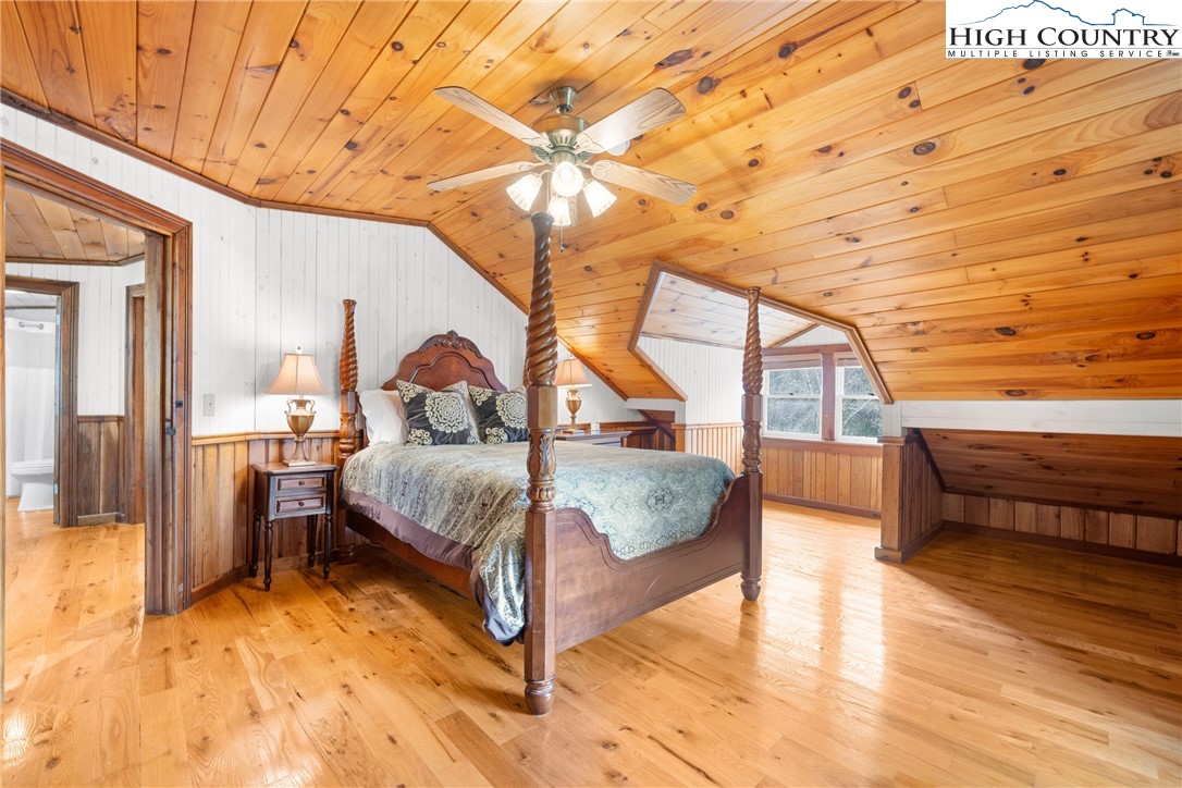 211 Possum Hollow Road Blowing Rock, NC 28605 - Photo 23 of 46 a bedroom with a bed and wooden floor