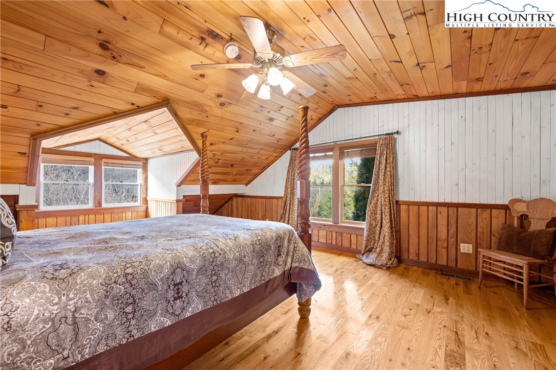 211 Possum Hollow Road Blowing Rock, NC 28605 - Photo 24 of 46 a bed sitting in a spacious bedroom next to a window