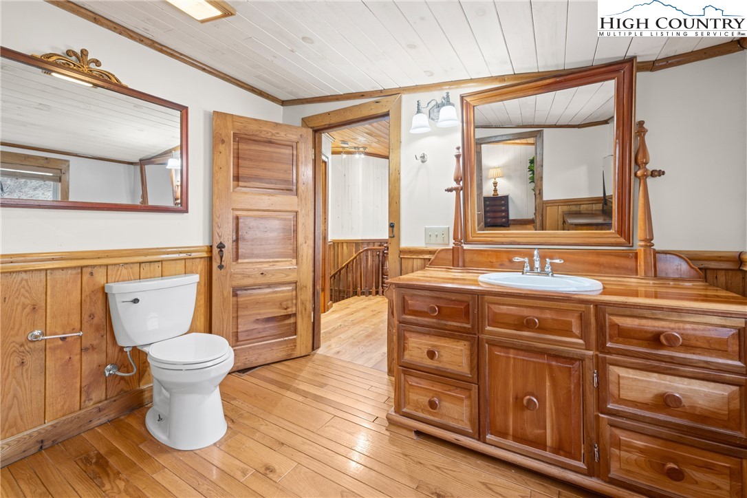 211 Possum Hollow Road Blowing Rock, NC 28605 - Photo 30 of 46 a bathroom with a toilet sink and mirror