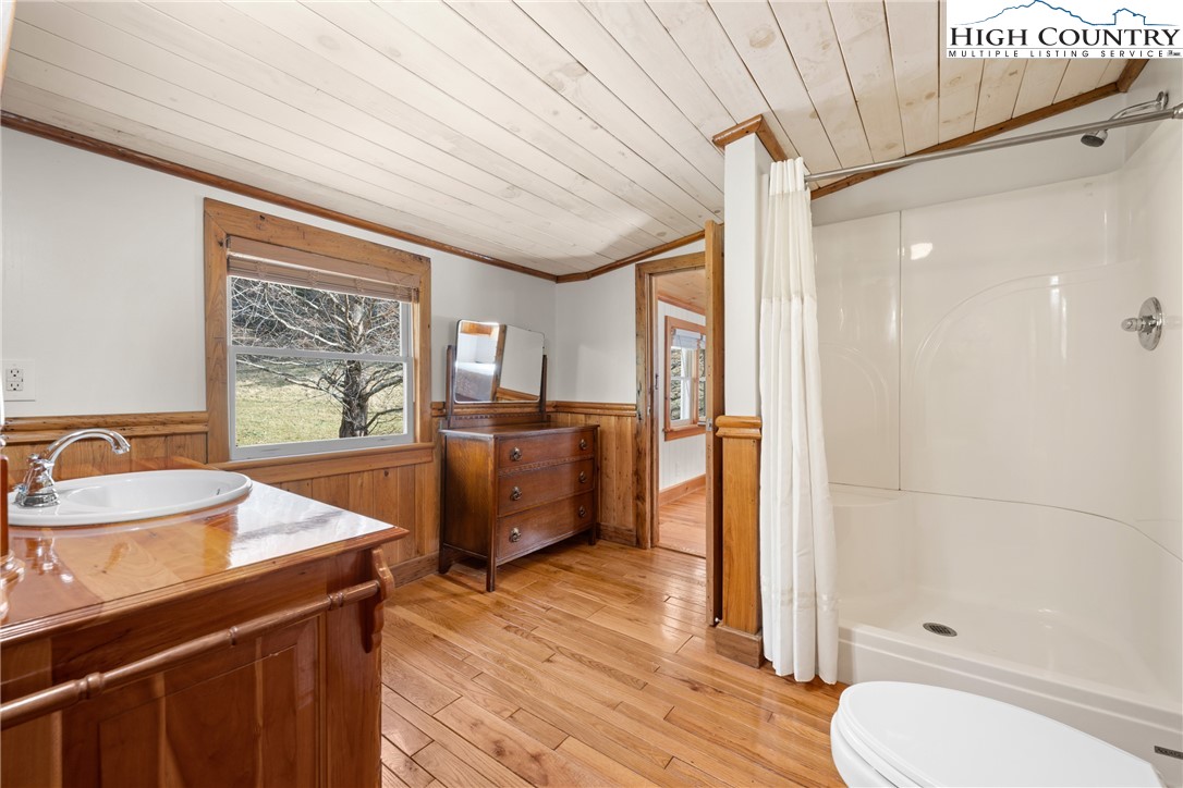 211 Possum Hollow Road Blowing Rock, NC 28605 - Photo 31 of 46 a bathroom with a sink a toilet a mirror and shower