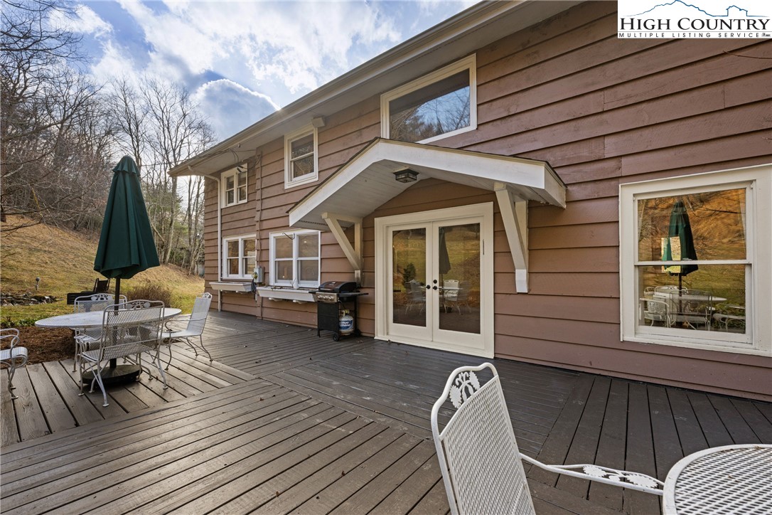 211 Possum Hollow Road Blowing Rock, NC 28605 - Photo 35 of 46 a view of a patio with table and chairs and wooden floor