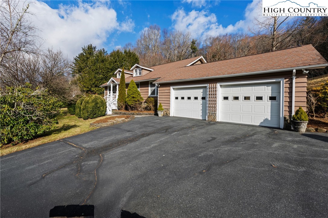 211 Possum Hollow Road Blowing Rock, NC 28605 - Photo 46 of 46 a front view of a house with a yard and garage