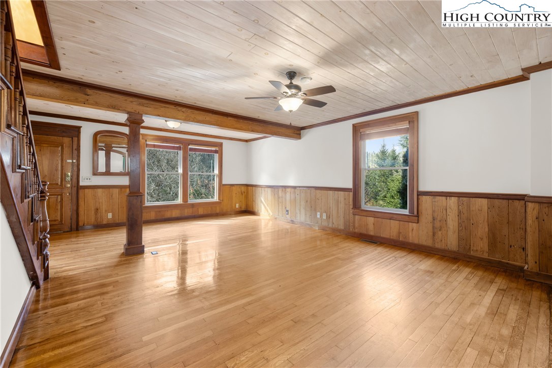 211 Possum Hollow Road Blowing Rock, NC 28605 - Photo 8 of 46 an empty room with wooden floor and windows