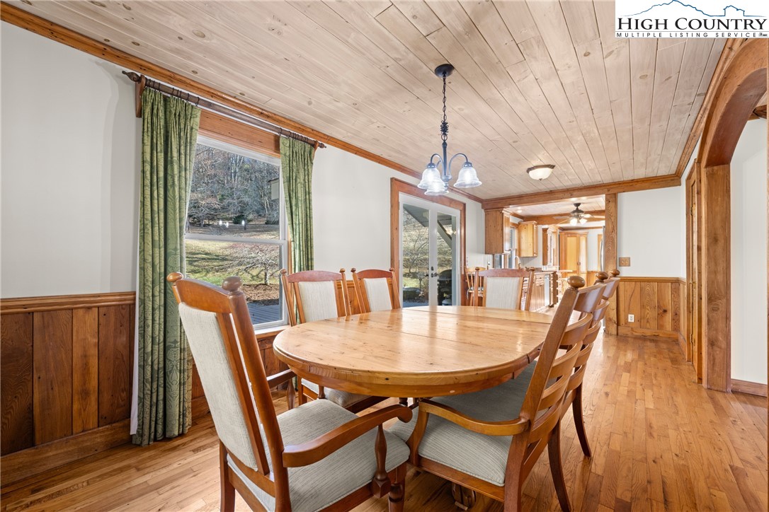 211 Possum Hollow Road Blowing Rock, NC 28605 - Photo 9 of 46 a view of a dining room with furniture window and wooden floor