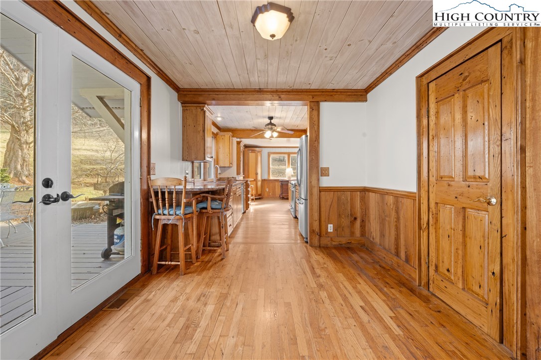 211 Possum Hollow Road Blowing Rock, NC 28605 - Photo 10 of 46 a view of a hallway with wooden floor and furniture