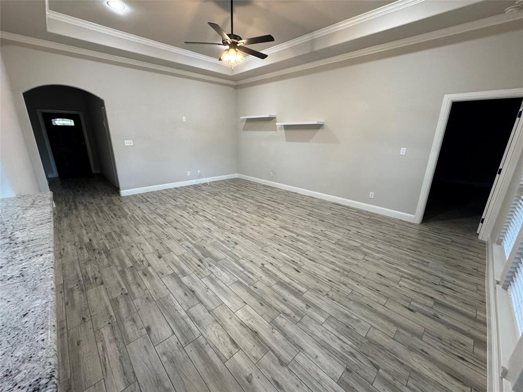 204 West 5th Street Springtown, TX 76082 - Photo 12 of 28 a view of empty room with wooden floor