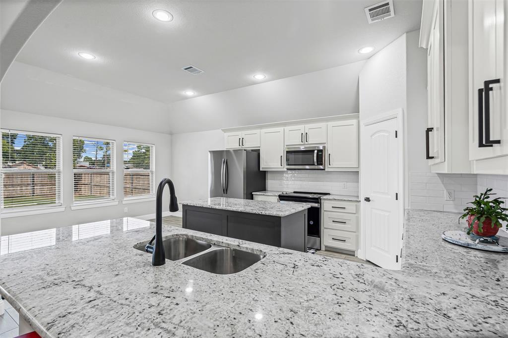 204 West 5th Street Springtown, TX 76082 - Photo 14 of 28 a kitchen with stainless steel appliances granite countertop a sink stove and refrigerator