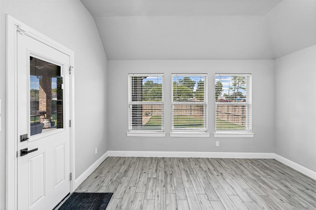 204 West 5th Street Springtown, TX 76082 - Photo 17 of 28 an empty room with wooden floor and windows