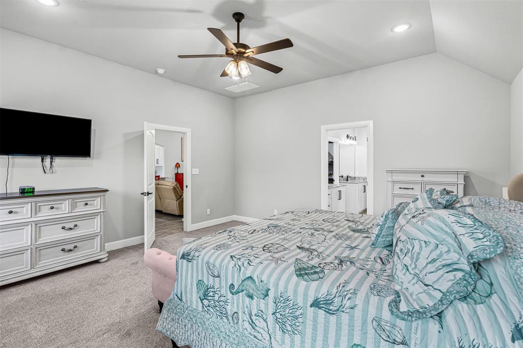 204 West 5th Street Springtown, TX 76082 - Photo 18 of 28 a bedroom with a bed and a flat screen tv