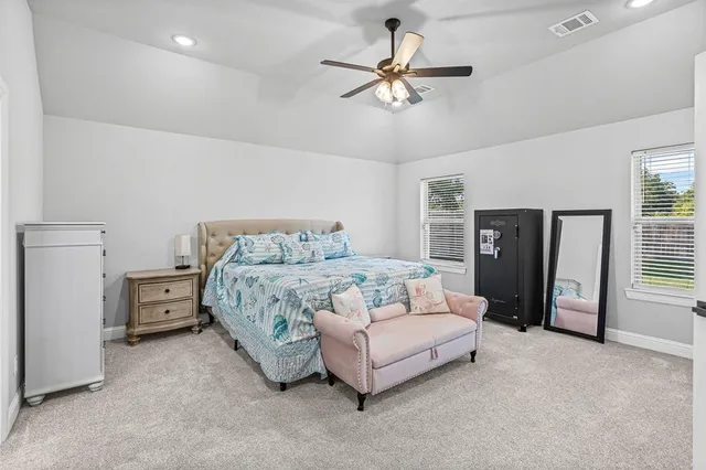 a bedroom with a bed and ceiling fan