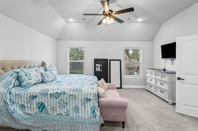 a bedroom with furniture and a flat screen tv