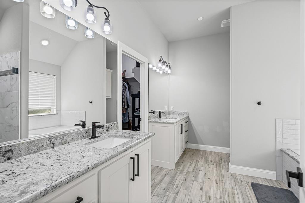 204 West 5th Street Springtown, TX 76082 - Photo 21 of 28 a bathroom with a sink double vanity granite and a mirror
