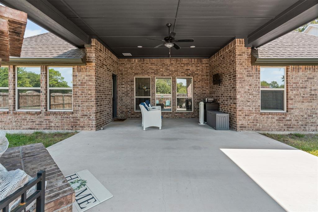 204 West 5th Street Springtown, TX 76082 - Photo 25 of 28 a view of a patio with a table and chairs
