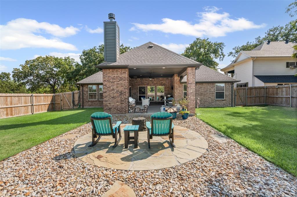 204 West 5th Street Springtown, TX 76082 - Photo 28 of 28 a view of a house with backyard sitting area and garden