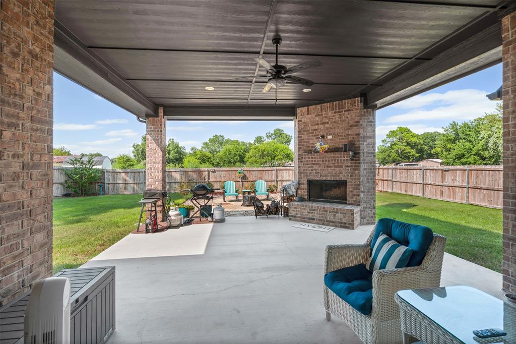204 West 5th Street Springtown, TX 76082 - Photo 4 of 28 a view of a patio with a table chairs and a yard