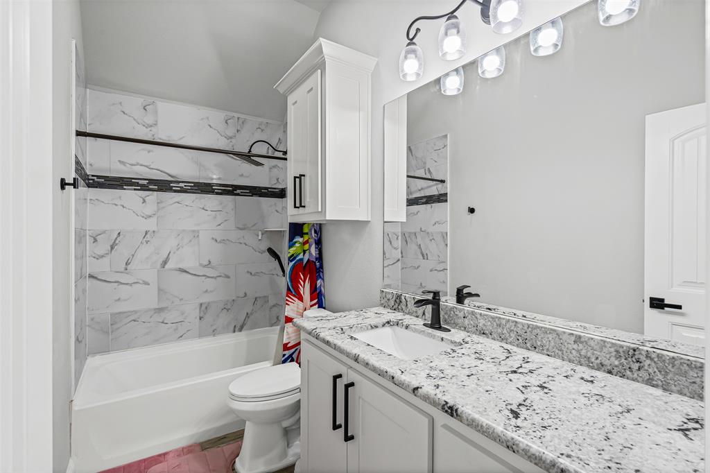 204 West 5th Street Springtown, TX 76082 - Photo 9 of 28 a bathroom with a sink a toilet and shower