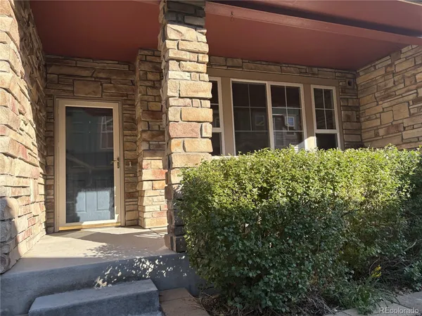 front view of a brick house with a large window