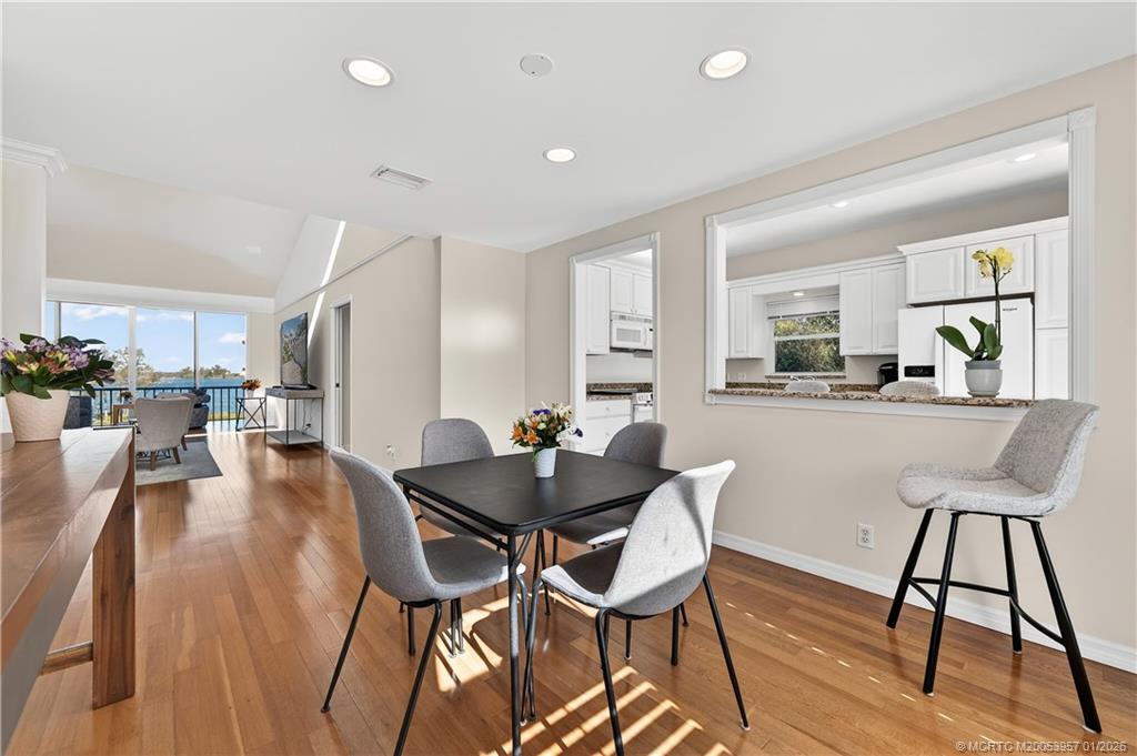 12400 Harbour Ridge Boulevard, Unit 58 Palm City, FL 34990 - Photo 14 of 42 a dining room with furniture and wooden floor