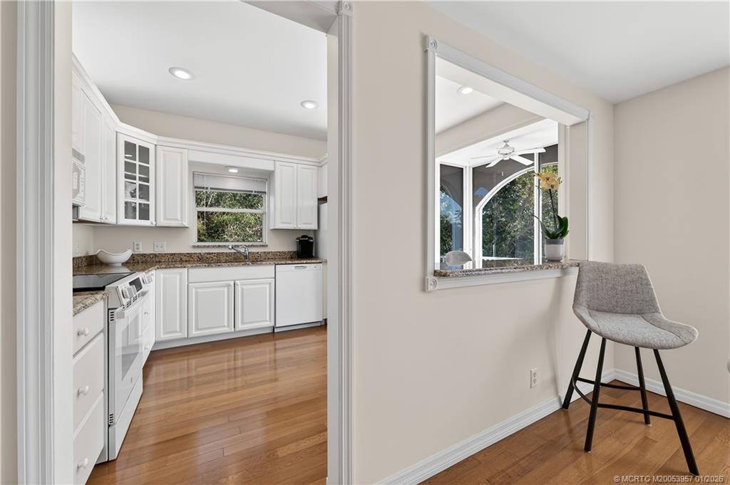 12400 Harbour Ridge Boulevard, Unit 58 Palm City, FL 34990 - Photo 15 of 42 a kitchen with stainless steel appliances granite countertop a stove a sink and a refrigerator