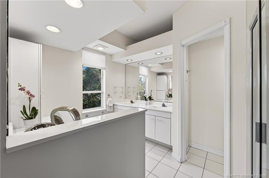 12400 Harbour Ridge Boulevard, Unit 58 Palm City, FL 34990 - Photo 23 of 42 a bathroom with a sink and a mirror