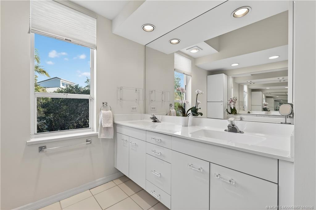 12400 Harbour Ridge Boulevard, Unit 58 Palm City, FL 34990 - Photo 25 of 42 a bathroom with a sink double vanity and a mirror