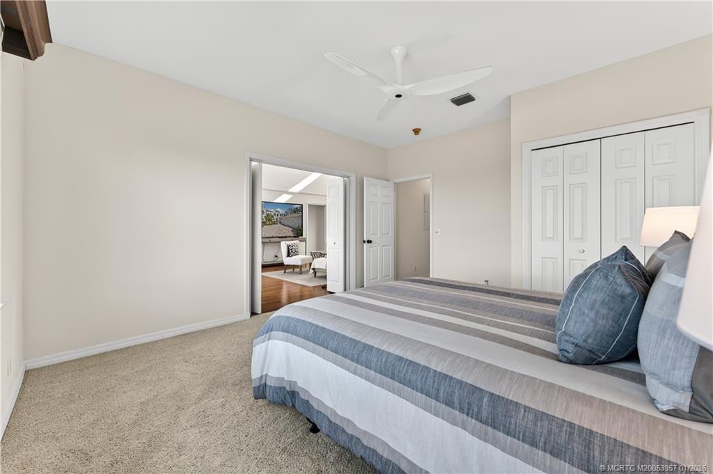 12400 Harbour Ridge Boulevard, Unit 58 Palm City, FL 34990 - Photo 27 of 42 a spacious bedroom with a bed and a cabinets