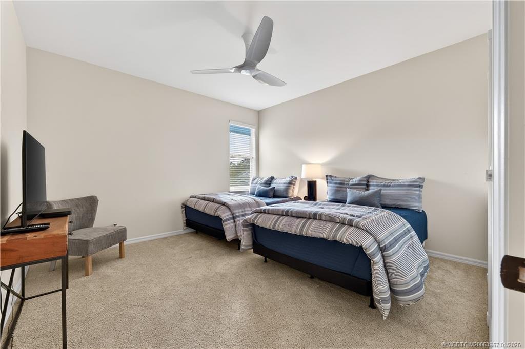 12400 Harbour Ridge Boulevard, Unit 58 Palm City, FL 34990 - Photo 28 of 42 a spacious bedroom with a bed and a window