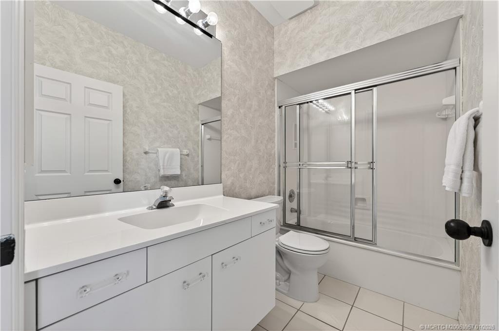 12400 Harbour Ridge Boulevard, Unit 58 Palm City, FL 34990 - Photo 29 of 42 a bathroom with a sink a toilet and shower