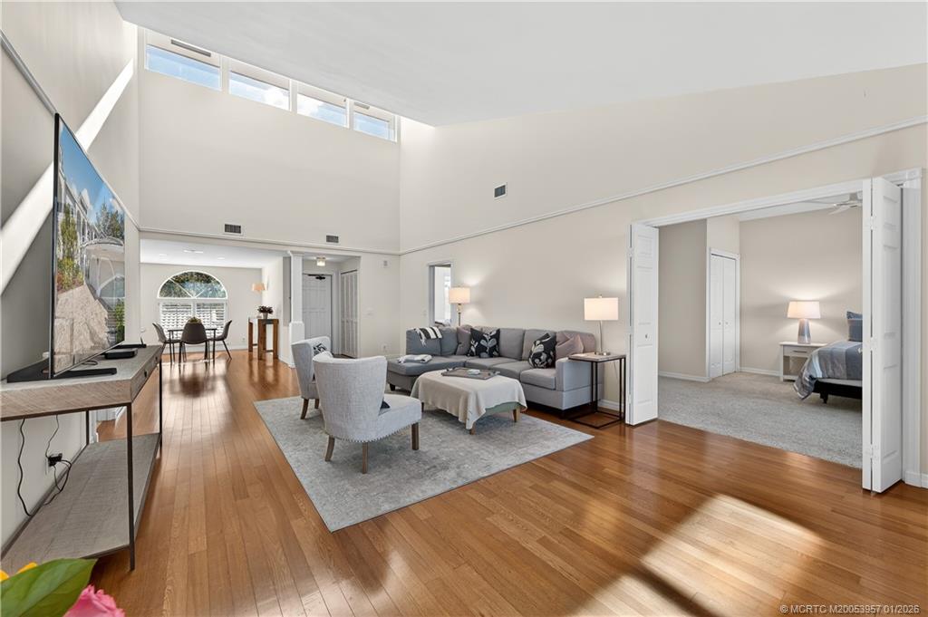 12400 Harbour Ridge Boulevard, Unit 58 Palm City, FL 34990 - Photo 7 of 42 a living room with furniture and a large window