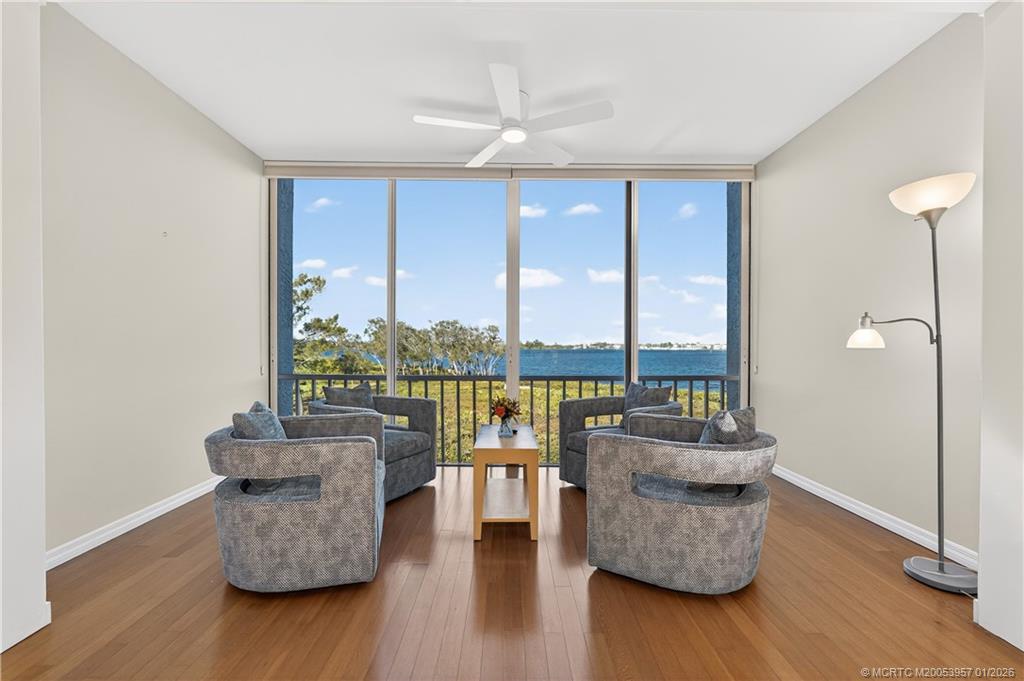 12400 Harbour Ridge Boulevard, Unit 58 Palm City, FL 34990 - Photo 9 of 42 a living room with furniture and a large window