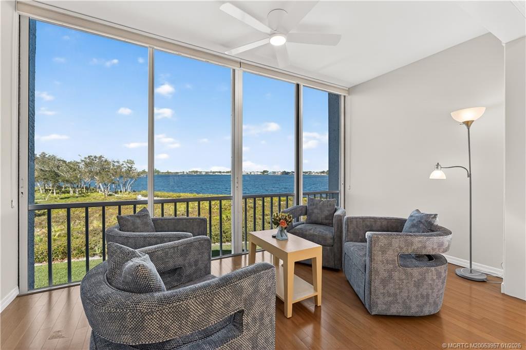 12400 Harbour Ridge Boulevard, Unit 58 Palm City, FL 34990 - Photo 10 of 42 a living room with furniture and a floor to ceiling window