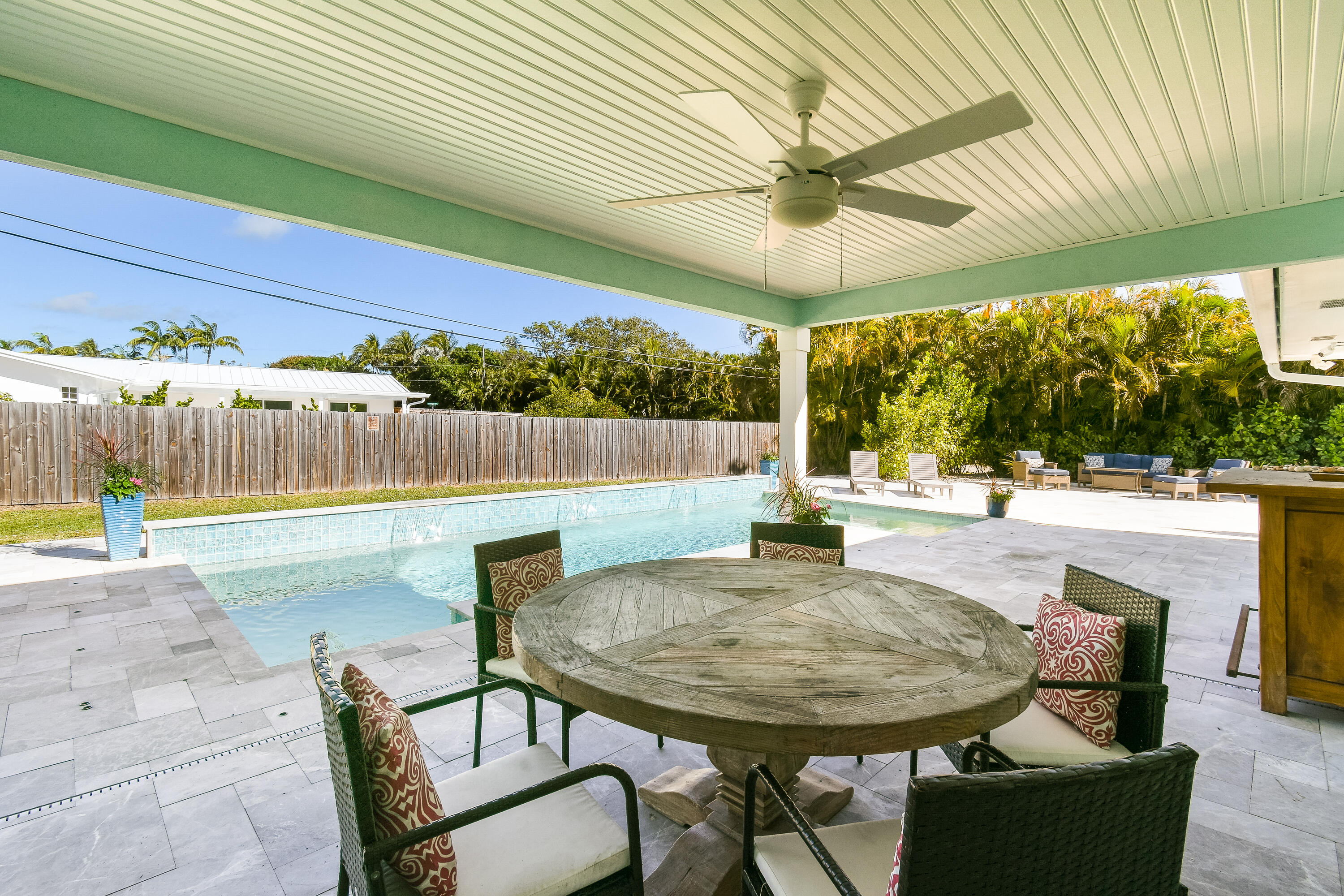 4835 Bimini Road Jupiter, FL 33469 - Photo 19 of 37 a view of a patio with a table and chairs