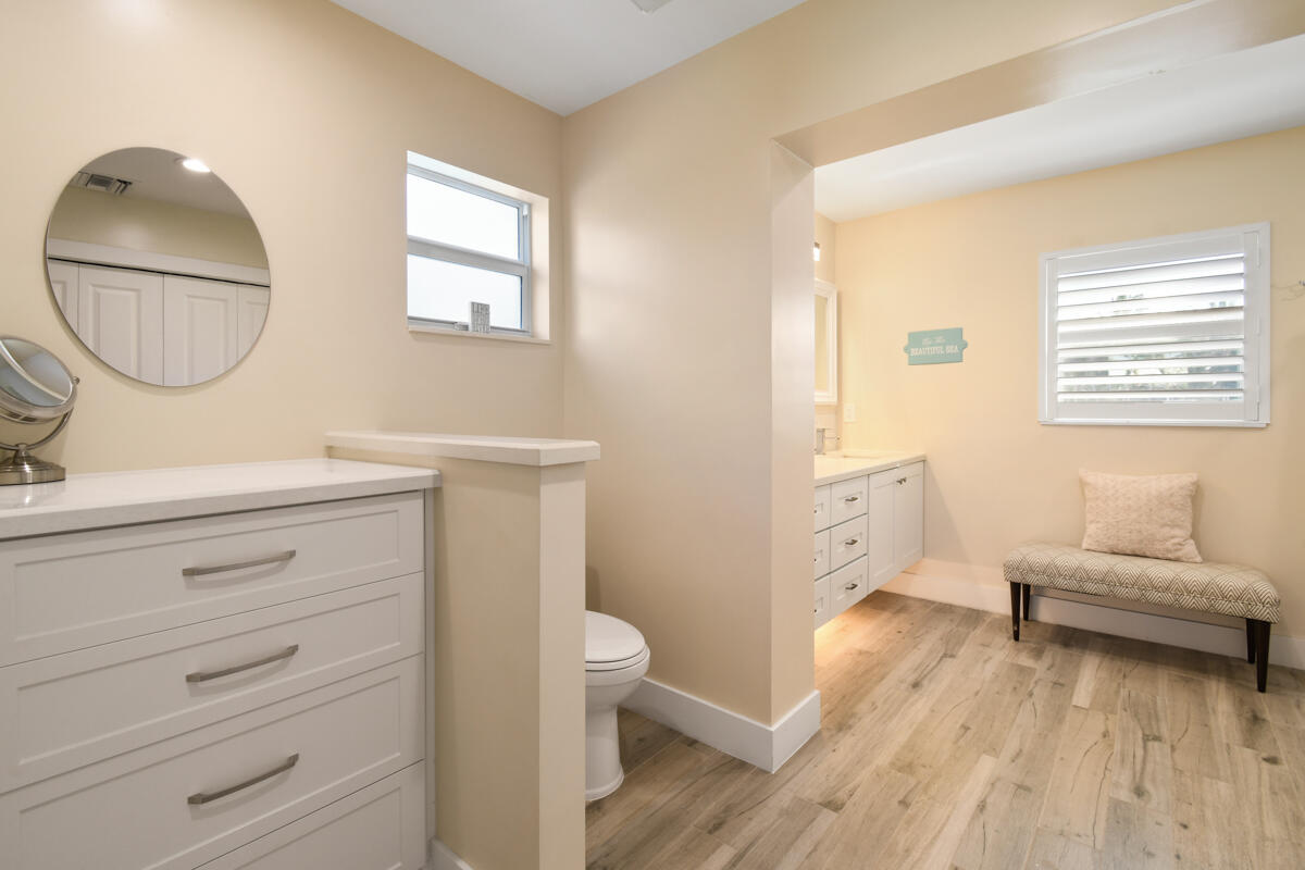 4835 Bimini Road Jupiter, FL 33469 - Photo 22 of 37 a en suite bathroom with a toilet a sink and a mirror