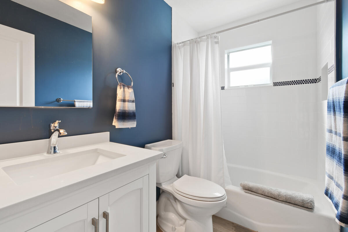 4835 Bimini Road Jupiter, FL 33469 - Photo 27 of 37 a bathroom with a sink toilet and shower