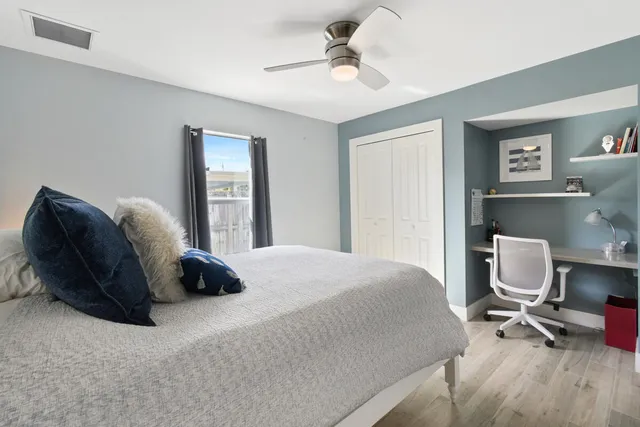 a bedroom with a bed a chair and a chandelier