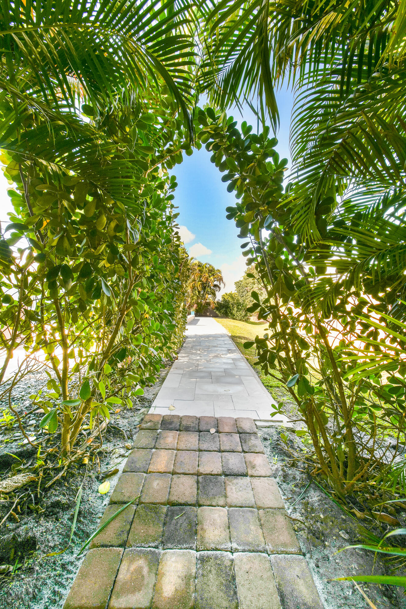 4835 Bimini Road Jupiter, FL 33469 - Photo 31 of 37 a view of a pathway both side of white house