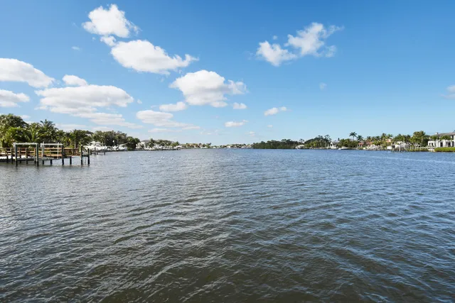 a view of a lake with houses in the back