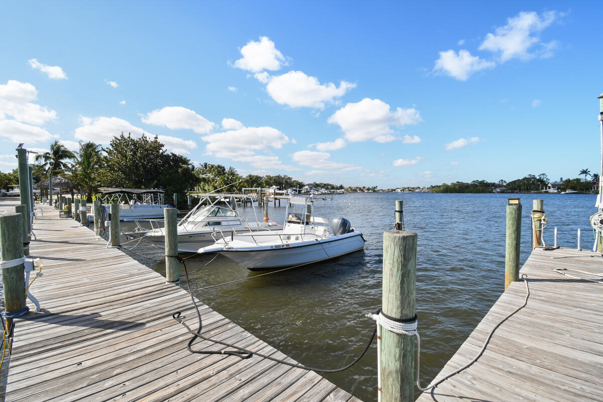 4835 Bimini Road Jupiter, FL 33469 - Photo 37 of 37 a view of a lake with boats and trees in the background