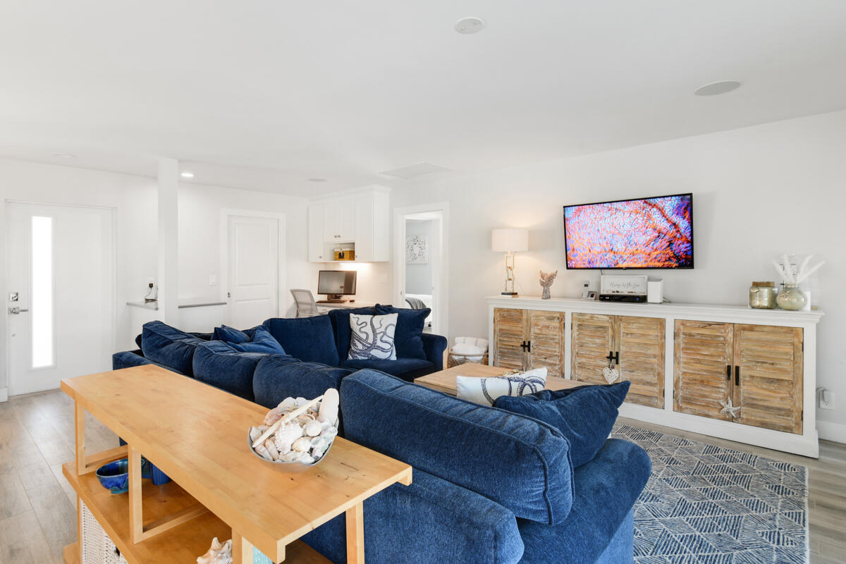 4835 Bimini Road Jupiter, FL 33469 - Photo 7 of 37 a living room with furniture and a kitchen view