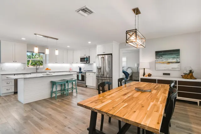 a large kitchen with a table and chairs
