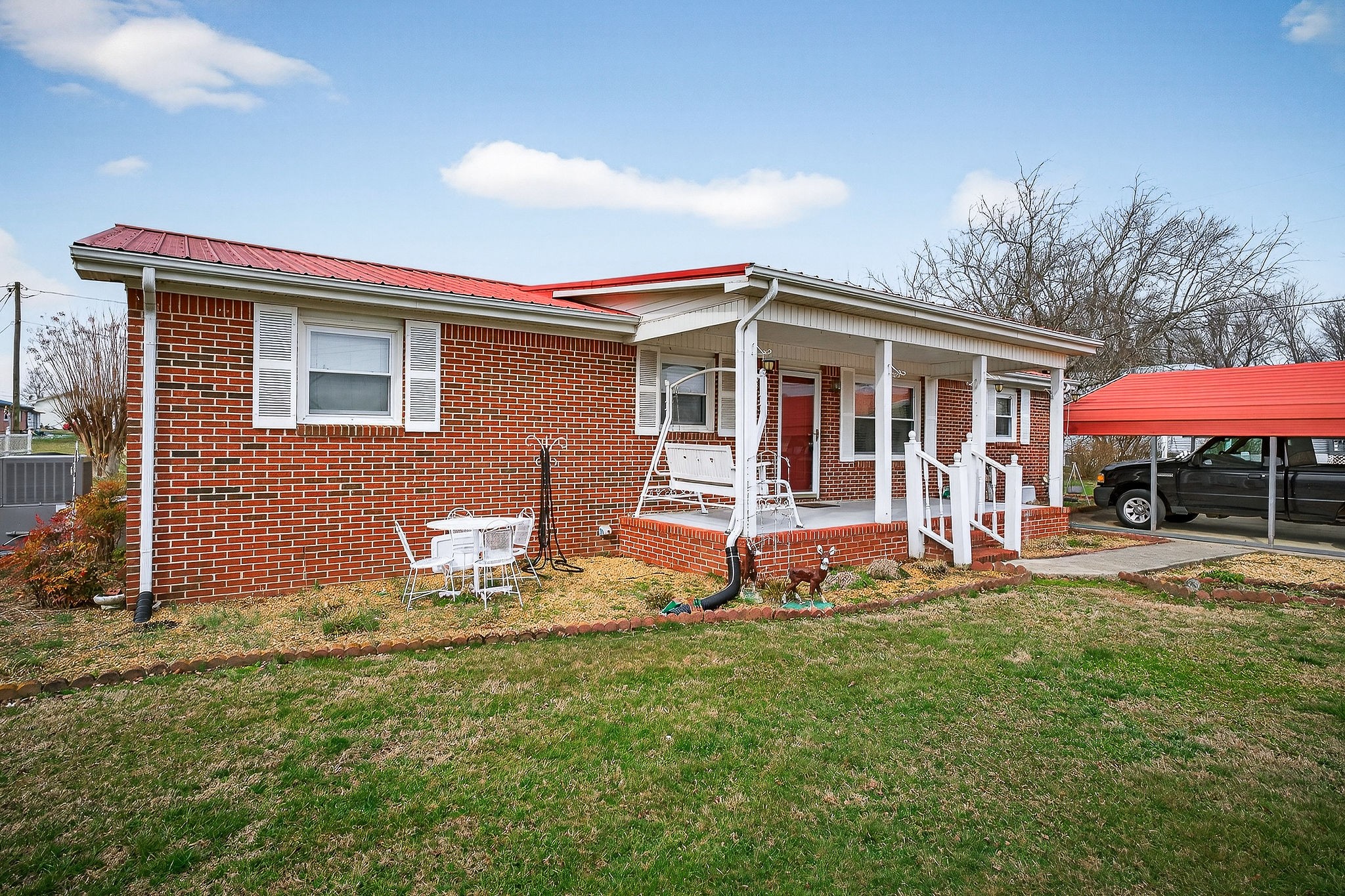 4463 Crisp Springs Road McMinnville, TN 37110 - Photo 2 of 26 a front view of a house with a yard and garage