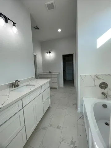 a bathroom with a double vanity sink and mirror