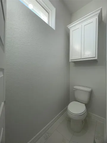 a white toilet sitting next to a sink