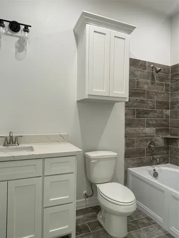 a bathroom with a sink a toilet and bathtub