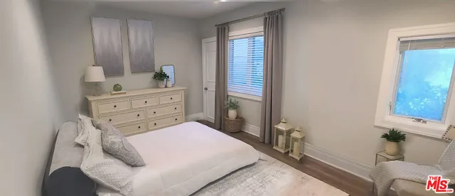 a bed room with a bed window and a mirror