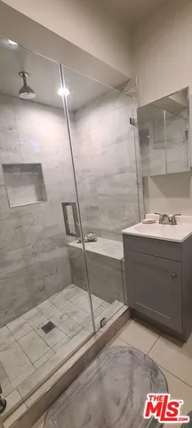 a bathroom with a shower and a sink